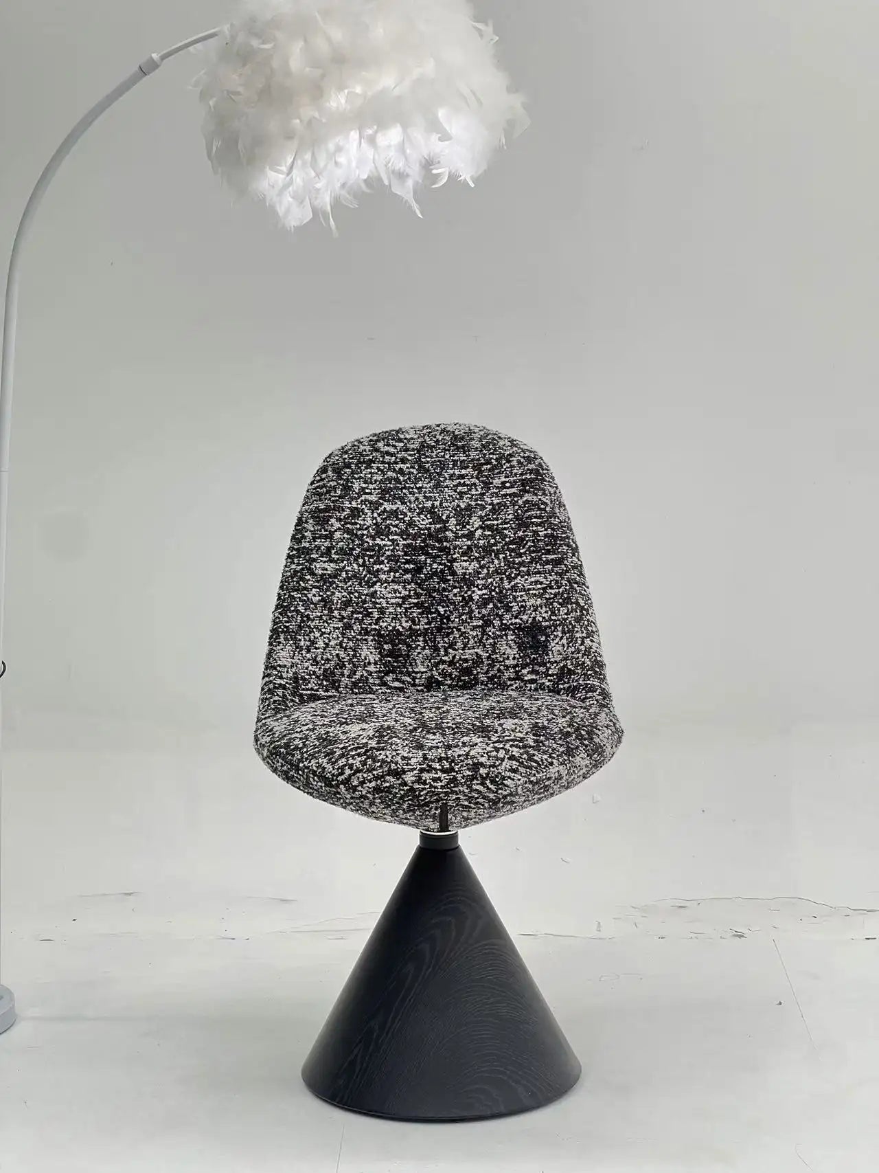 Black White Speckled Swivel Chair with Black Cone Base ¨C Artistic Modern Accent Seating for Boutique Hotels & Commercial Lounges