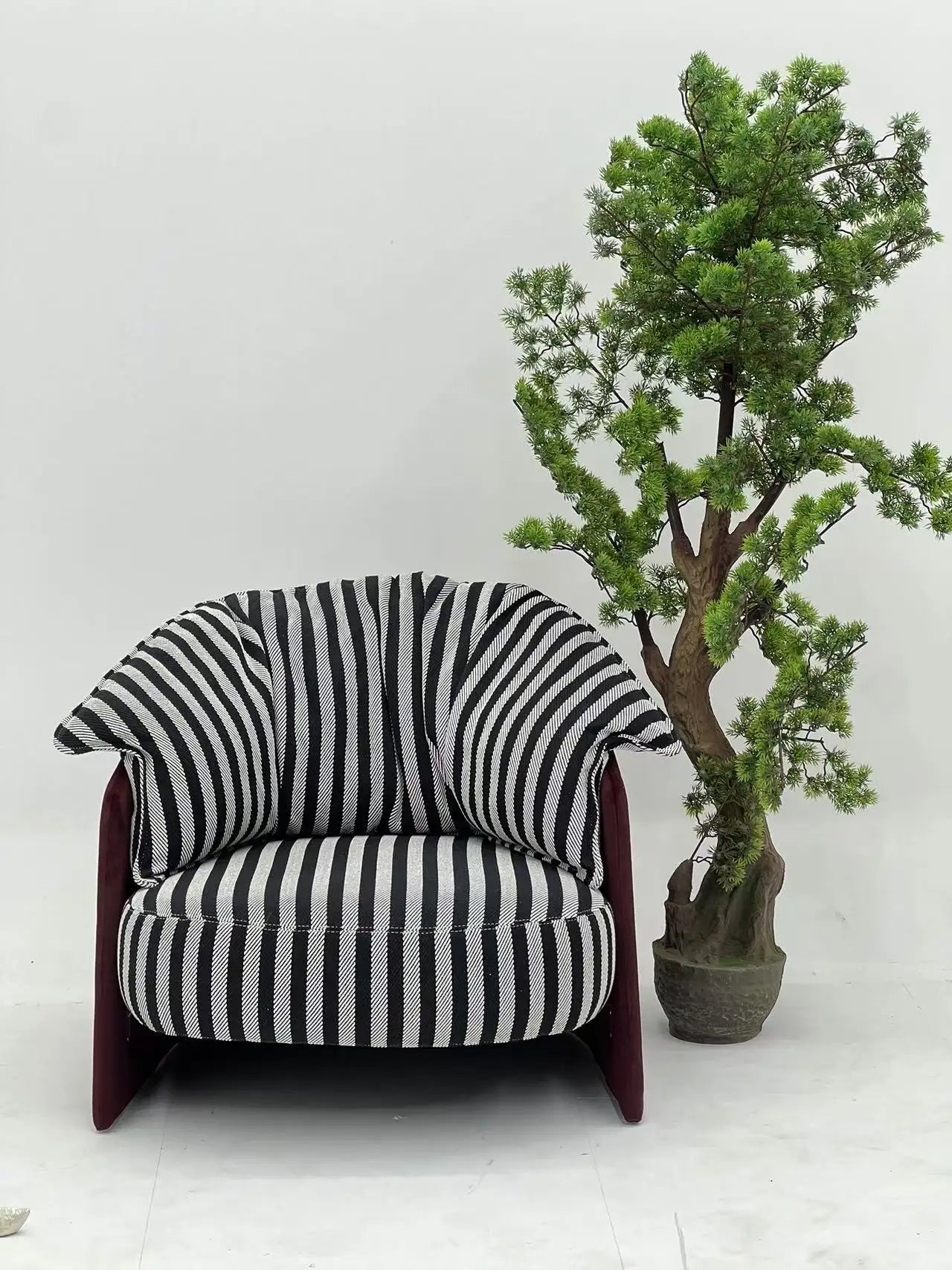 Black White Striped Boucle Lounge Chair with Burgundy Base ¨C Luxurious Modern Accent Seating for Boutique Hotels & Commercial Spaces