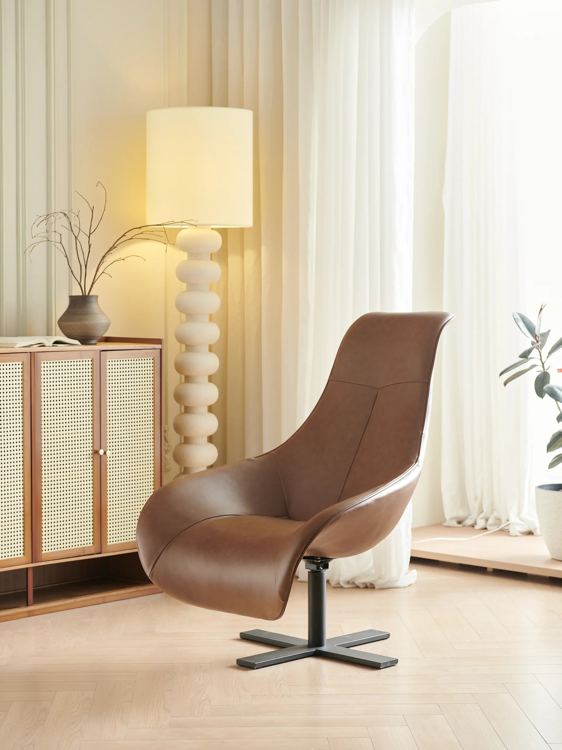 Brown Leather Swivel Lounge Chair with Black Cross Base ¨C Luxurious Modern Accent Seating for Boutique Hotels & Commercial Spaces